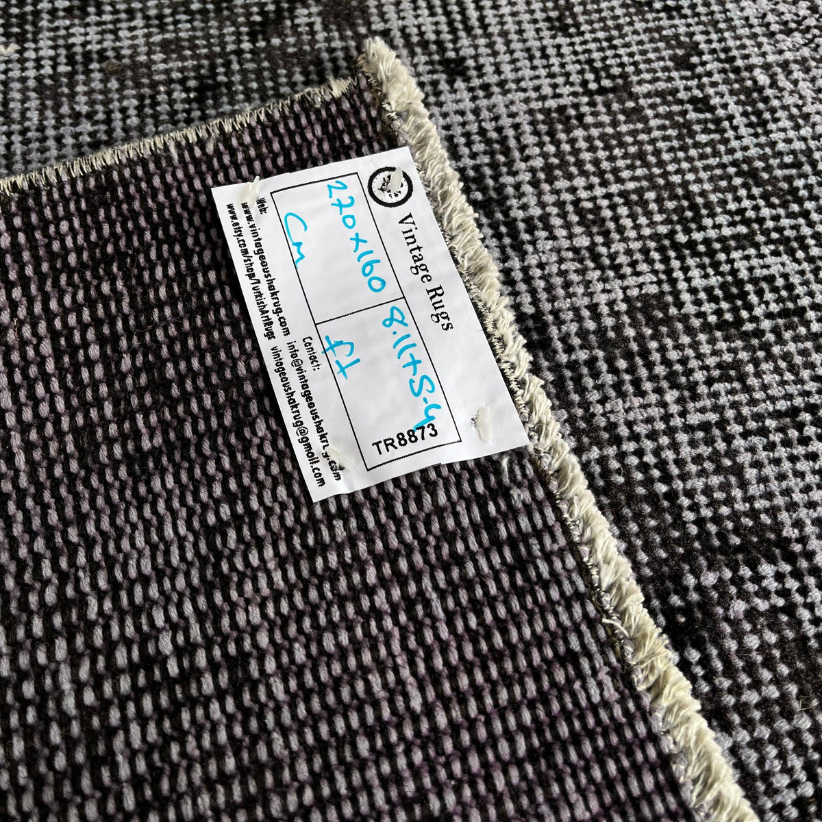 Close-up of the gray vintage Turkish overdyed rug showing overdyed details, hand-knotted weave, wool and cotton and low pile.