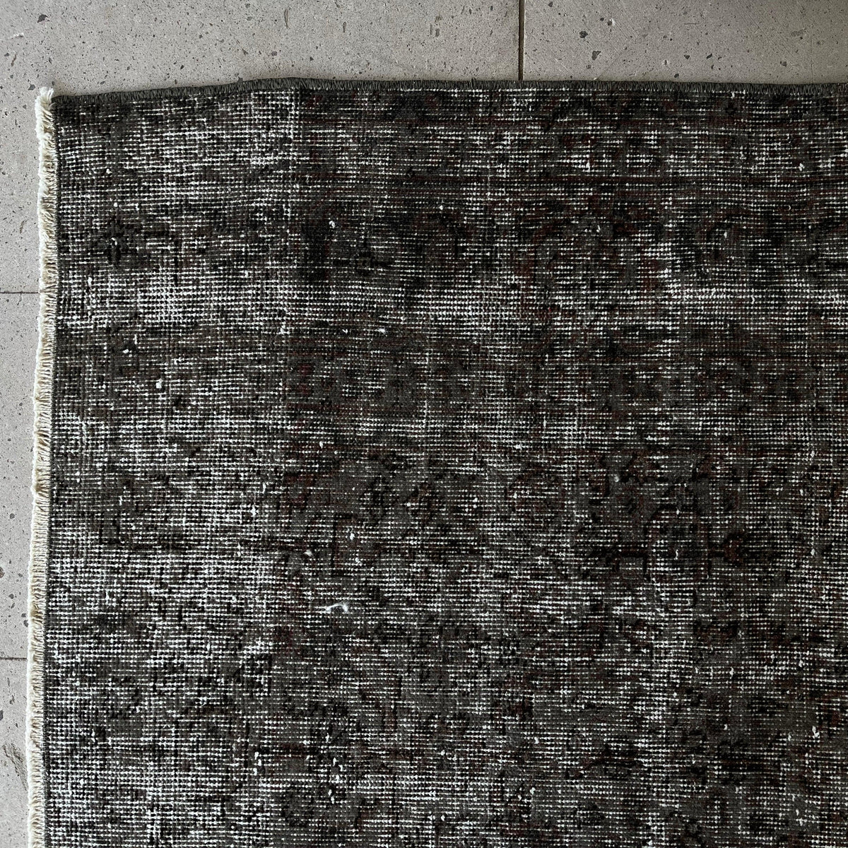 1970s black vintage Turkish overdyed rug with overdyed design, hand-knotted weave and low pile.