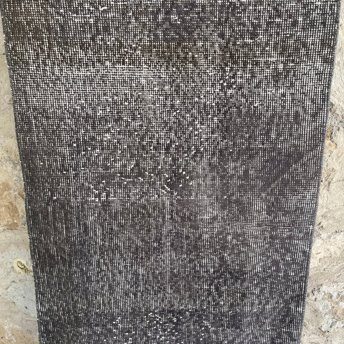 Gray 2' x 9' vintage Turkish overdyed runner rug in wool and cotton, shown on the floor.