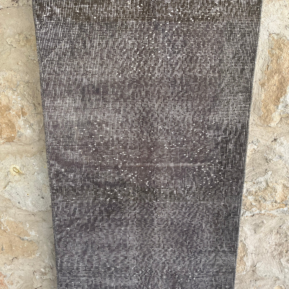 Gray 2' x 9' vintage Turkish overdyed runner rug in wool and cotton, shown on the floor.