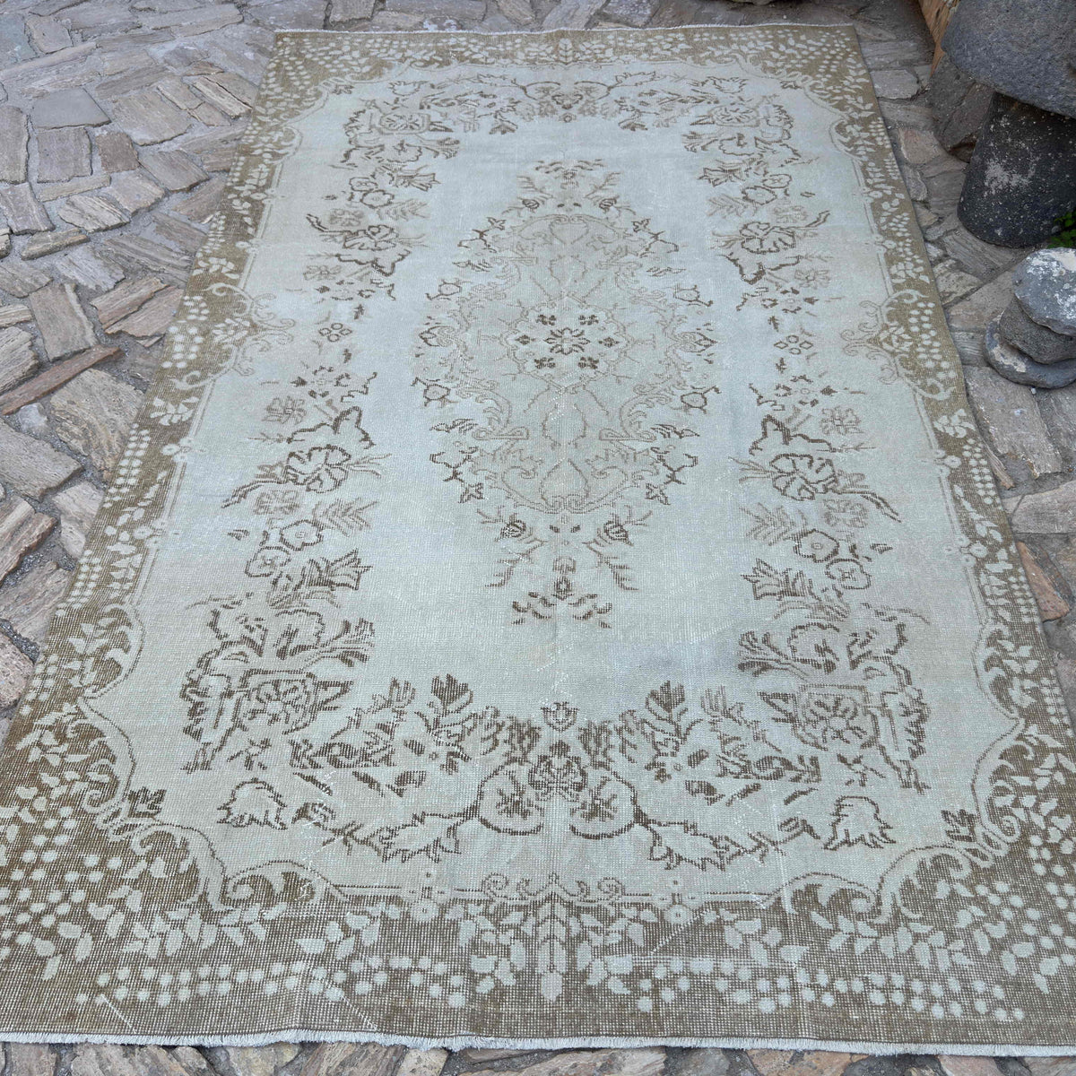 Beige 6' x 9' vintage Turkish persian rug in wool and cotton, shown on the floor.