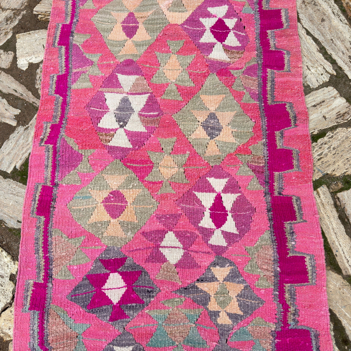1970s pink vintage persian runner rug with medallion design, hand-knotted weave and low pile.
