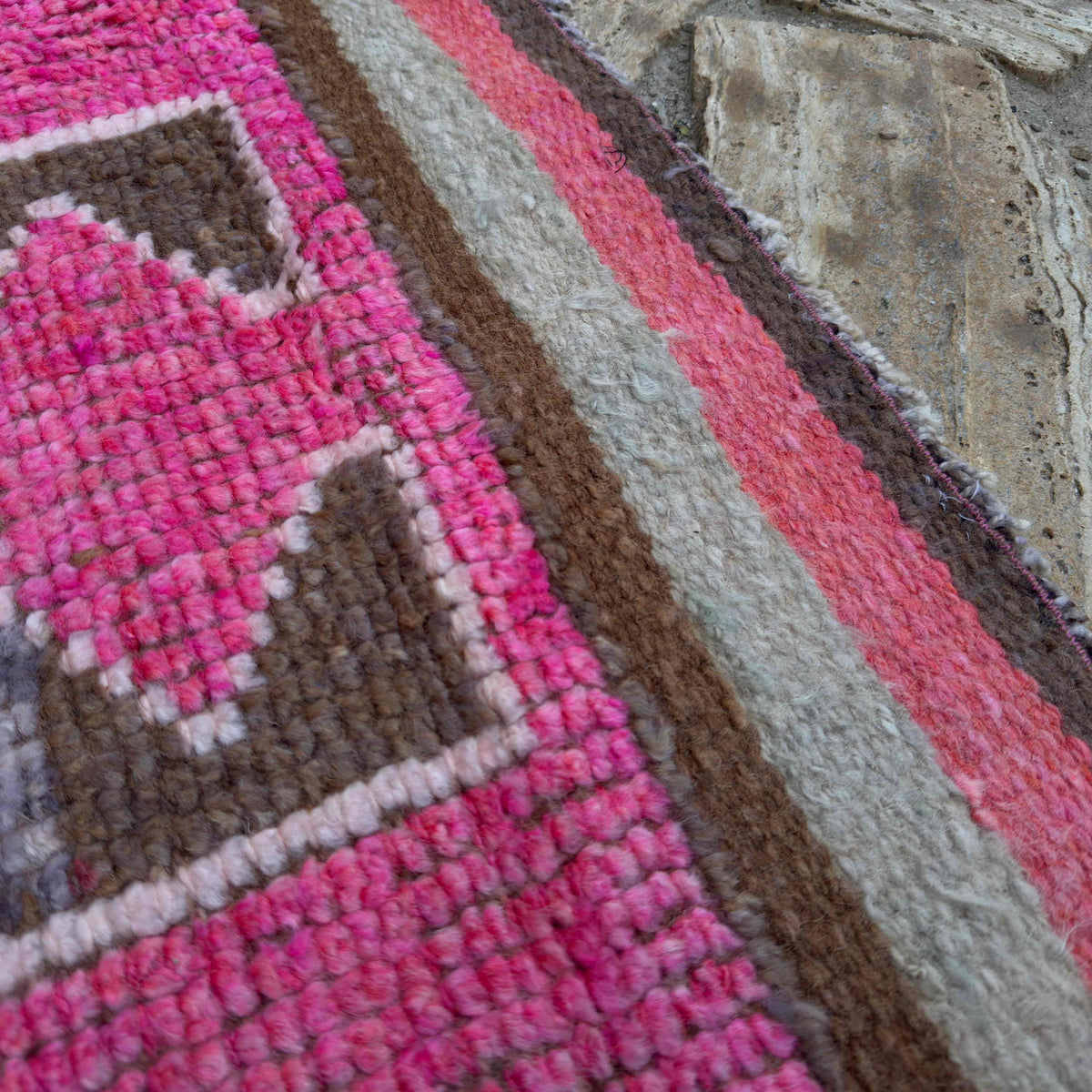 Close-up of the pink vintage persian runner rug showing traditional details, hand-knotted weave, wool and cotton and low pile.