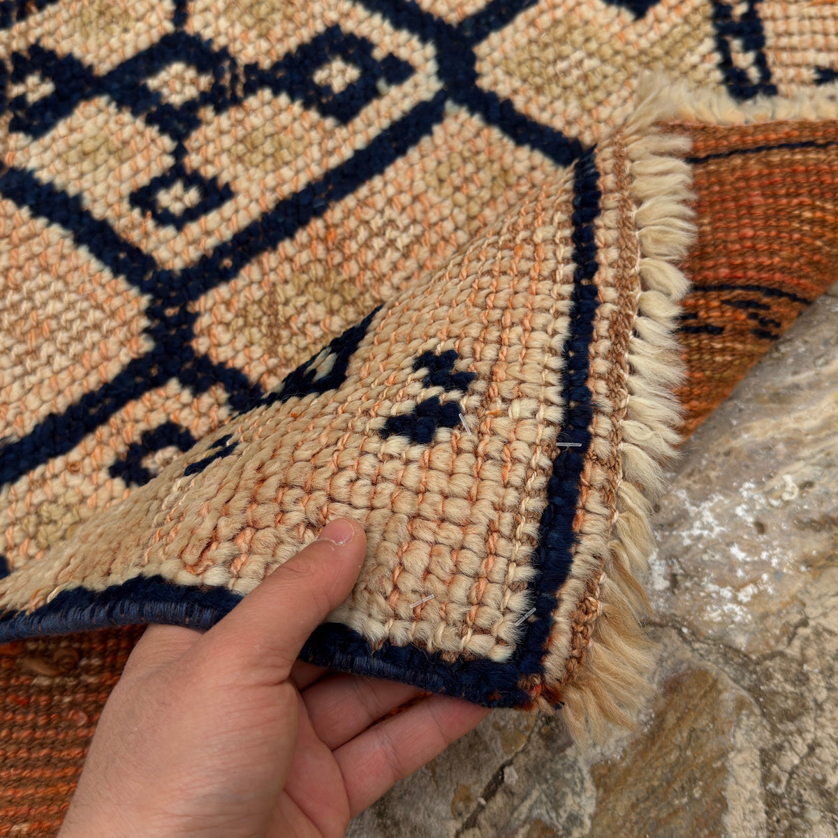 Close-up of the pale orange vintage persian runner rug showing traditional details, hand-knotted weave, wool and low pile.