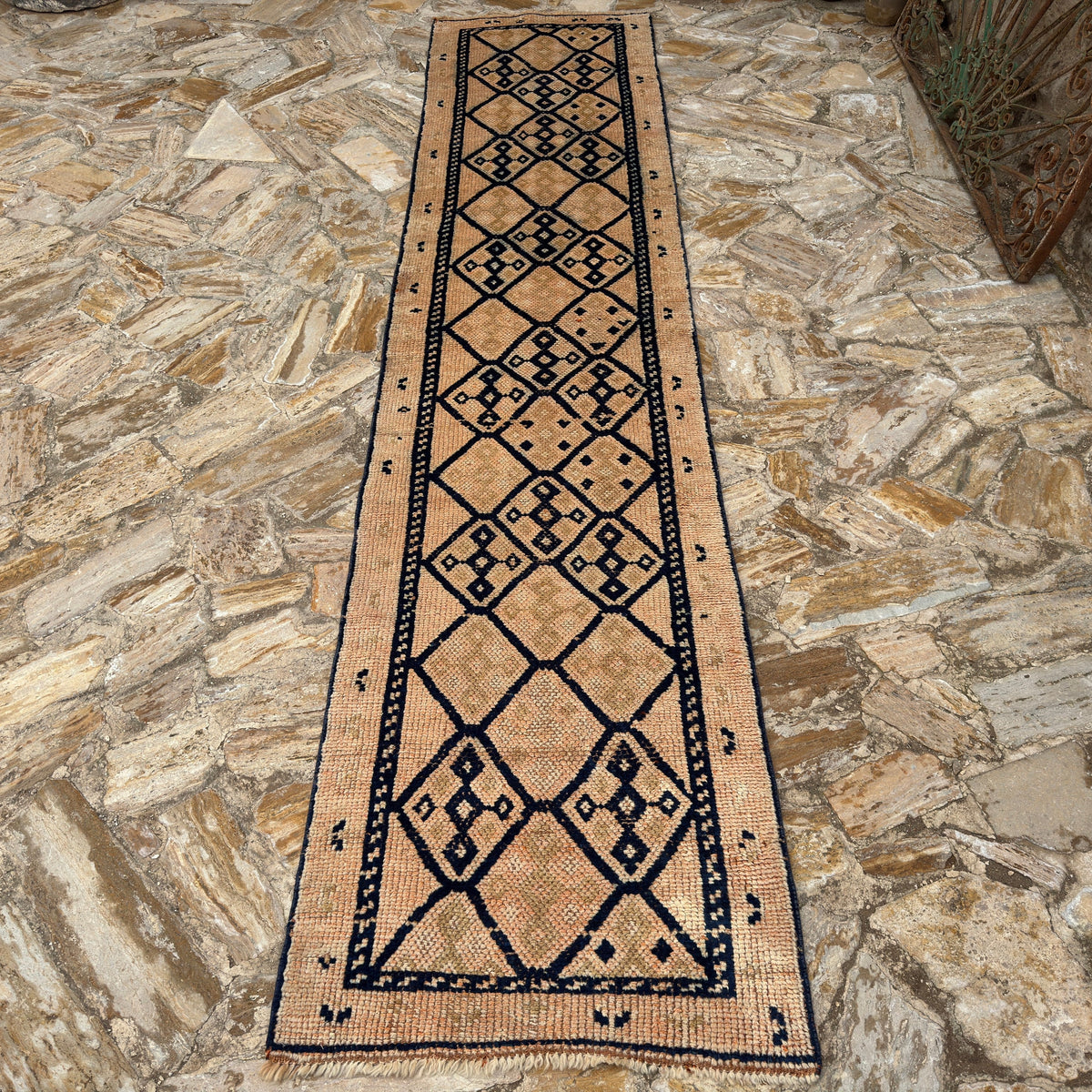 Pale Orange 3' x 12' vintage persian runner rug in wool, shown on the floor.