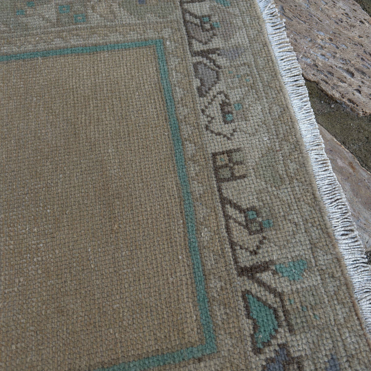 Close-up of the beige vintage Turkish prayer rug showing traditional details, hand-knotted weave, wool and cotton and low pile.