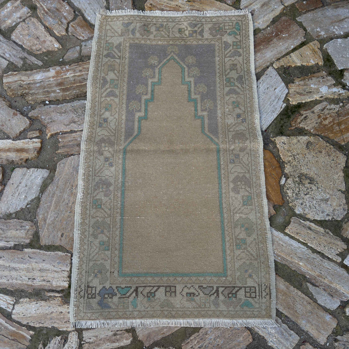 Beige 2' x 4' vintage Turkish prayer rug in wool and cotton, shown on the floor.
