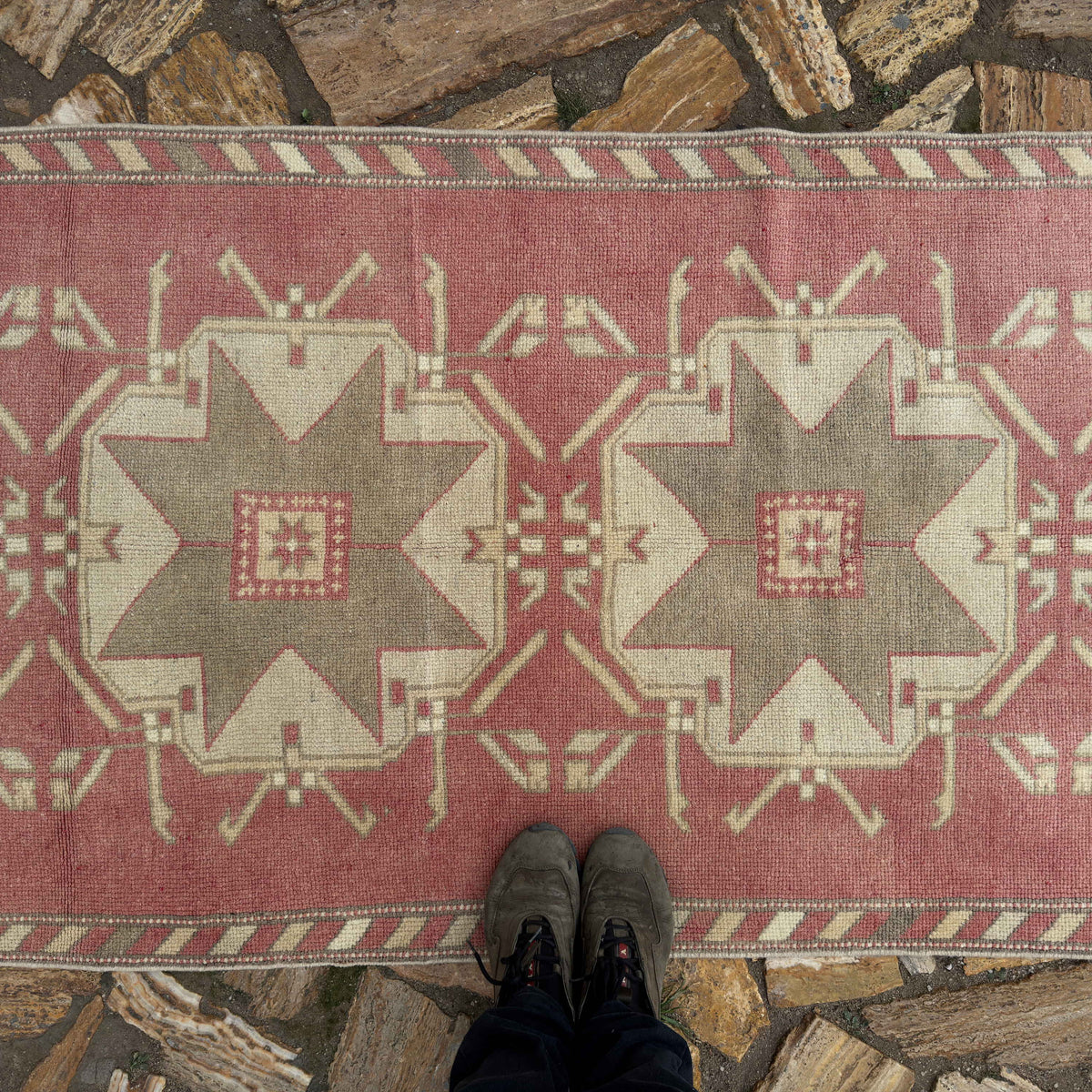 1970s pale red vintage Turkish runner carpet with traditional design, hand-knotted weave and low pile.