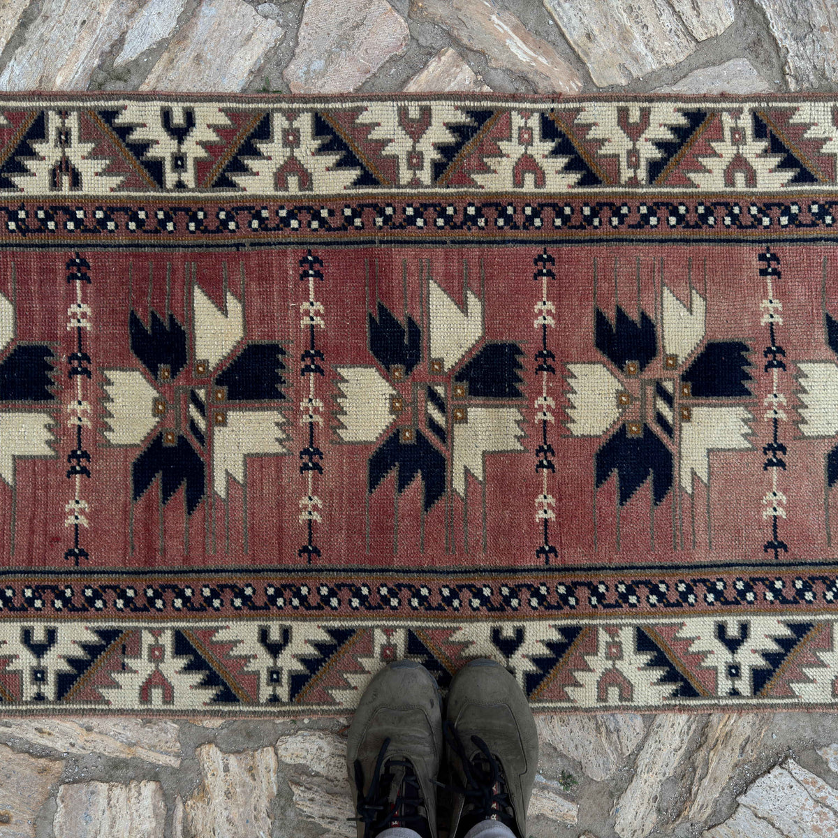1970s pale red vintage Turkish runner rug with traditional design, hand-knotted weave and low pile.