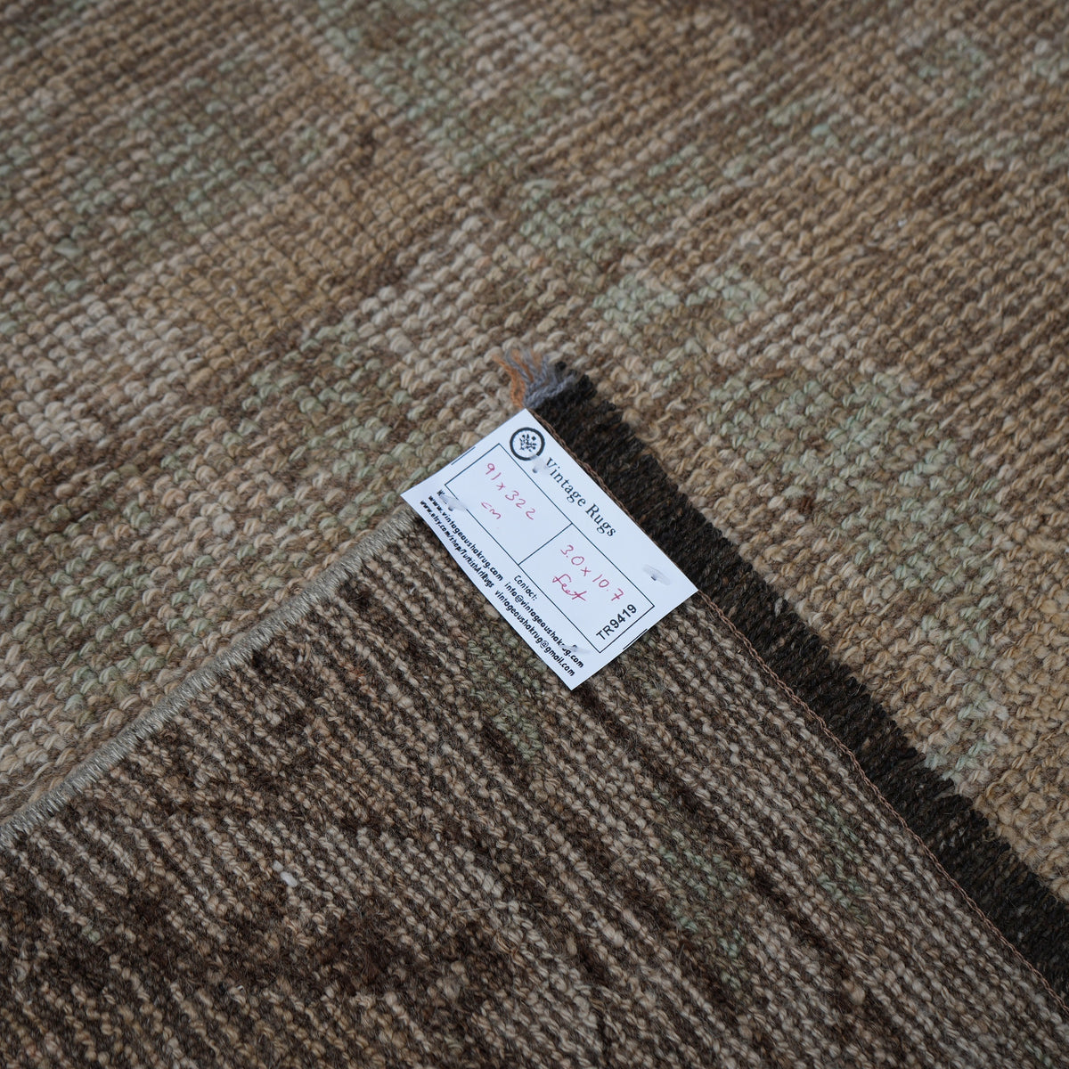 Beige 3' x 11' vintage Turkish runner rug from the 1970s with neutral design.