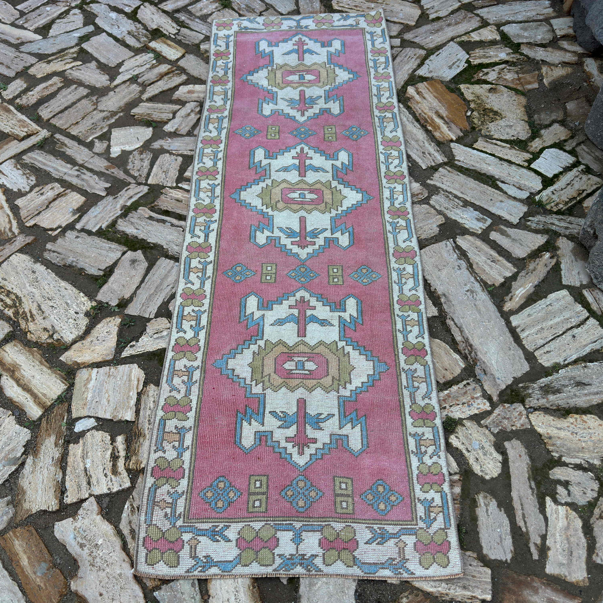 1970s pink vintage Turkish runner rug with traditional design, hand-knotted weave and low pile.