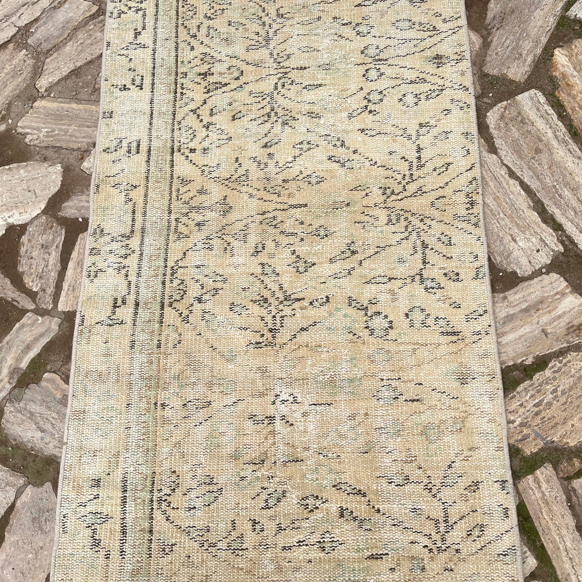1970s beige vintage Turkish runner rug with floral design, hand-knotted weave and low pile.