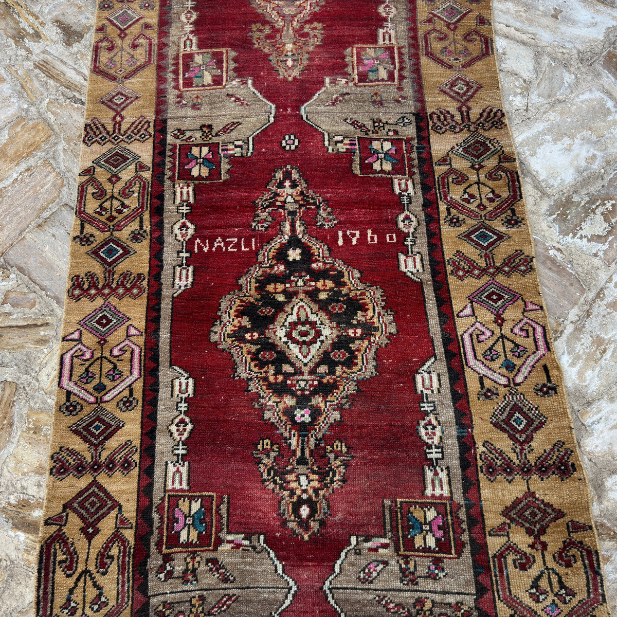 Red 3' x 9' vintage Turkish runner rug in wool and cotton, shown on the floor.