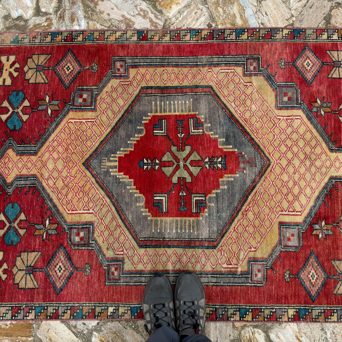 1970s red vintage Turkish runner rug with traditional design, hand-knotted weave and low pile.