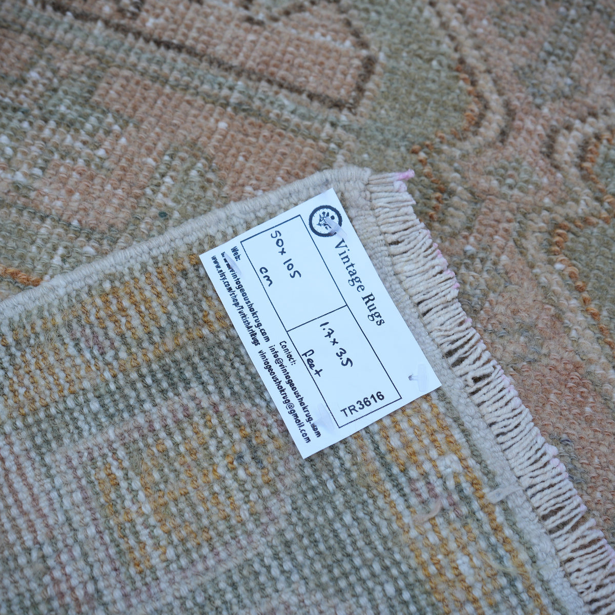 Pink 2' x 3' vintage Turkish small rug from the 1970s with neutral design.