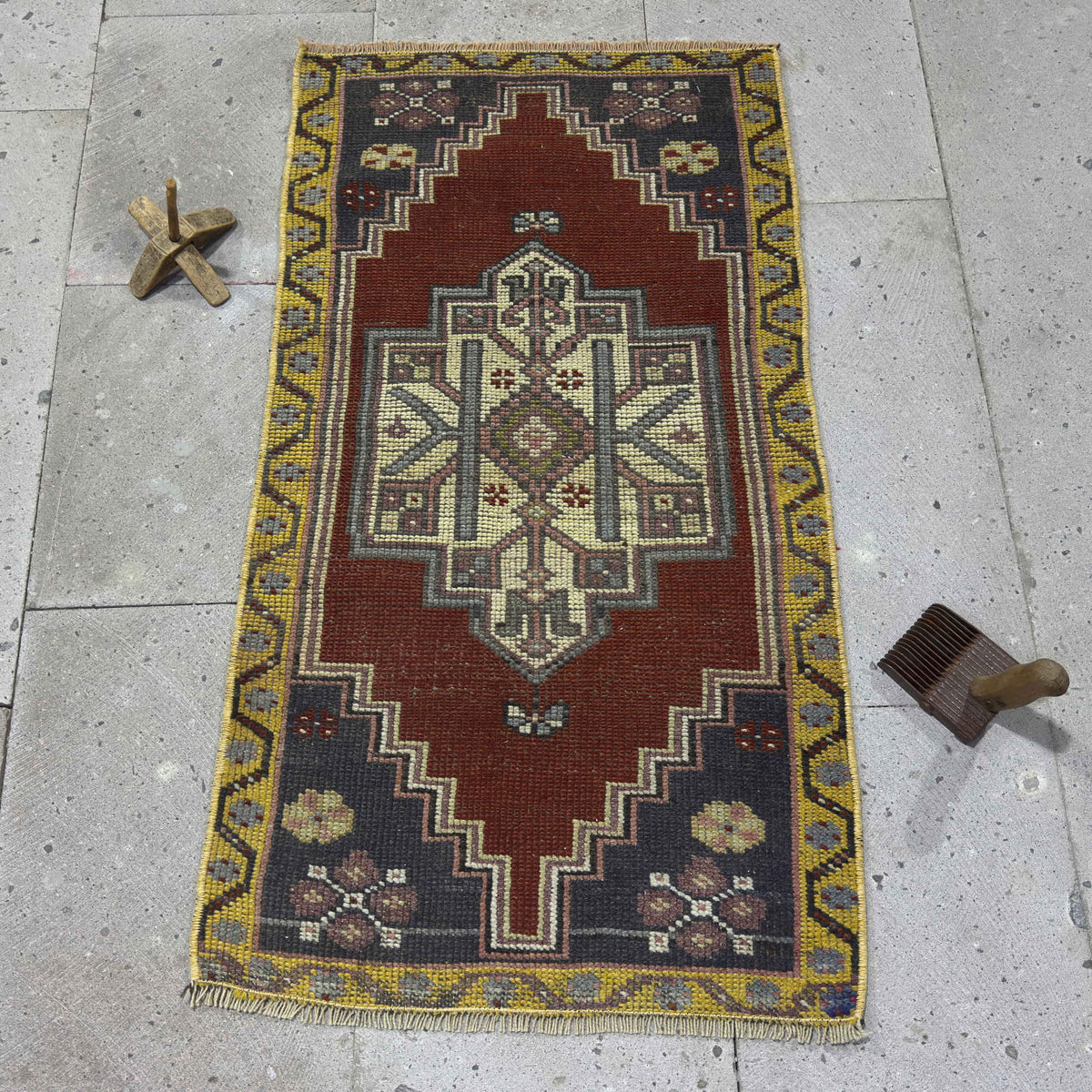 Red 2' x 3' vintage Turkish small rug in wool and cotton, shown on the floor.