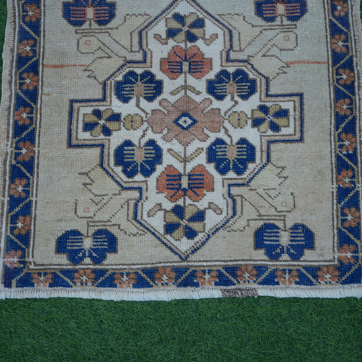 Close-up of the blue vintage Turkish square rug showing traditional details, hand-knotted weave, wool and cotton and low pile.