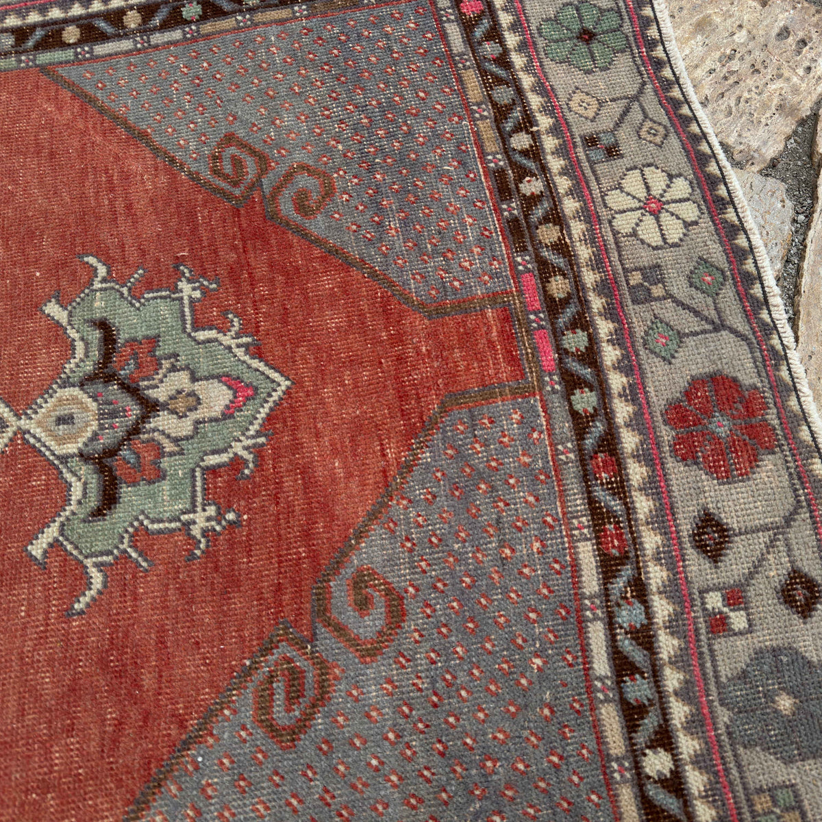 Close-up of the red vintage Turkish traditional runner rug showing medallion details, hand-knotted weave, wool and cotton and low pile.