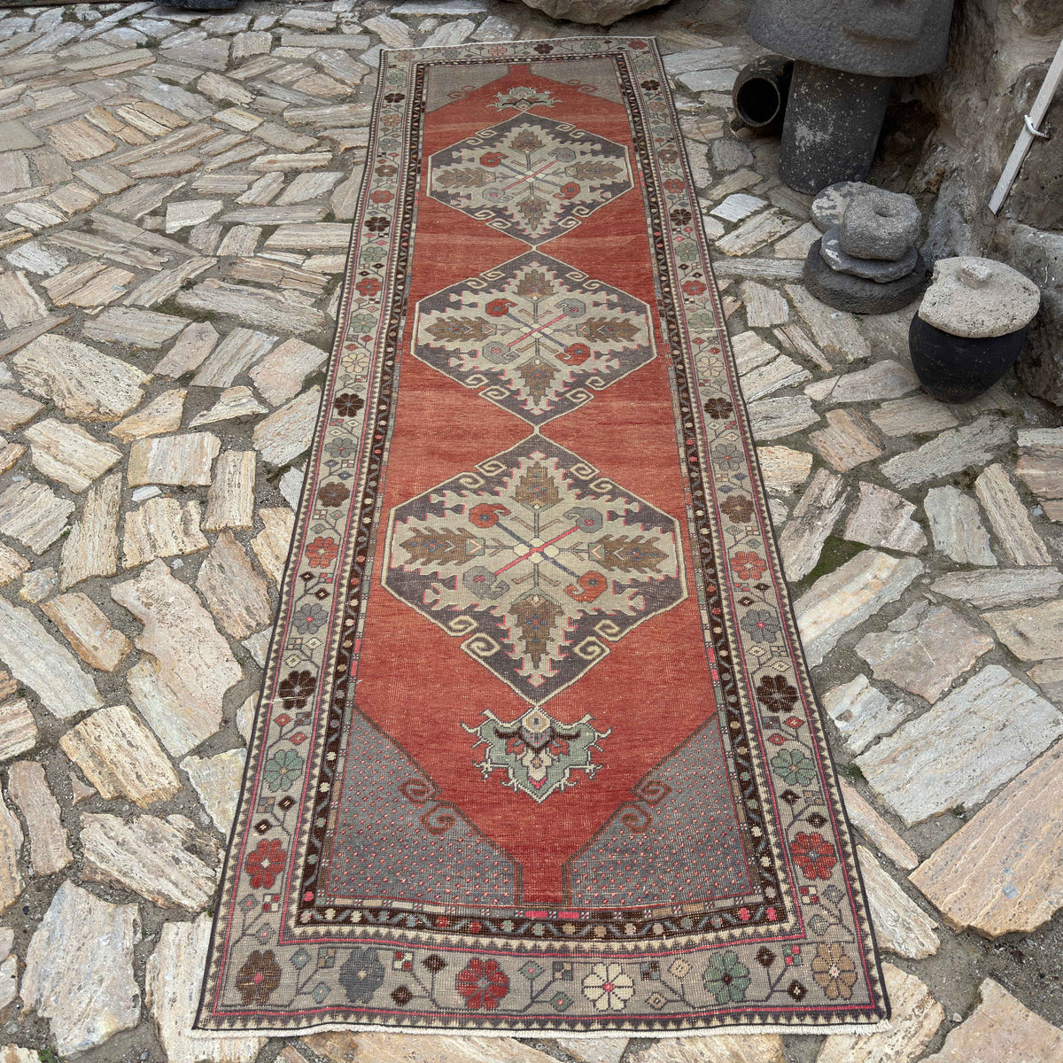 Red 3' x 11' vintage Turkish traditional runner rug in wool and cotton, shown on the floor.