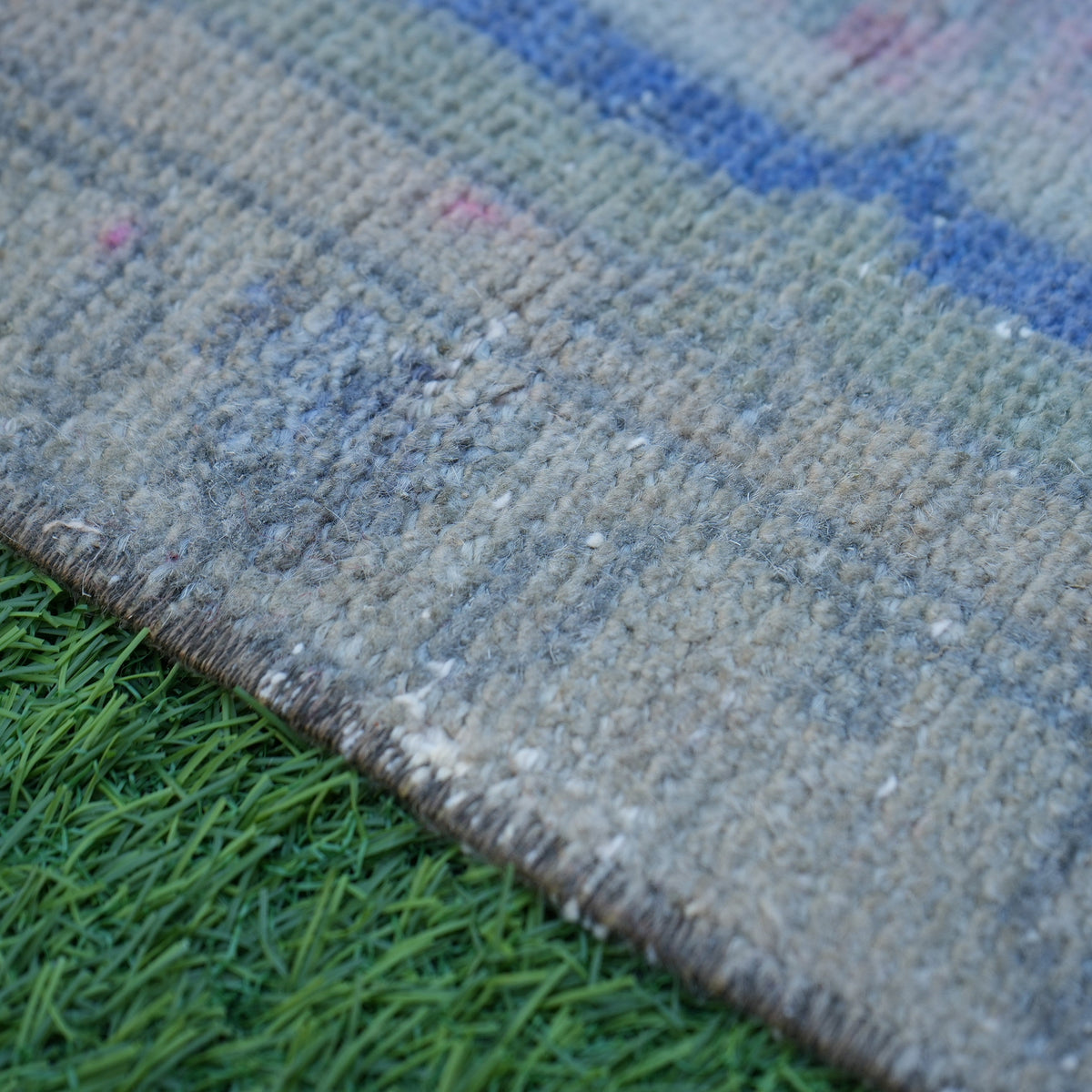 Beige 1' x 3' vintage turkish rug in wool and cotton, shown on the floor.