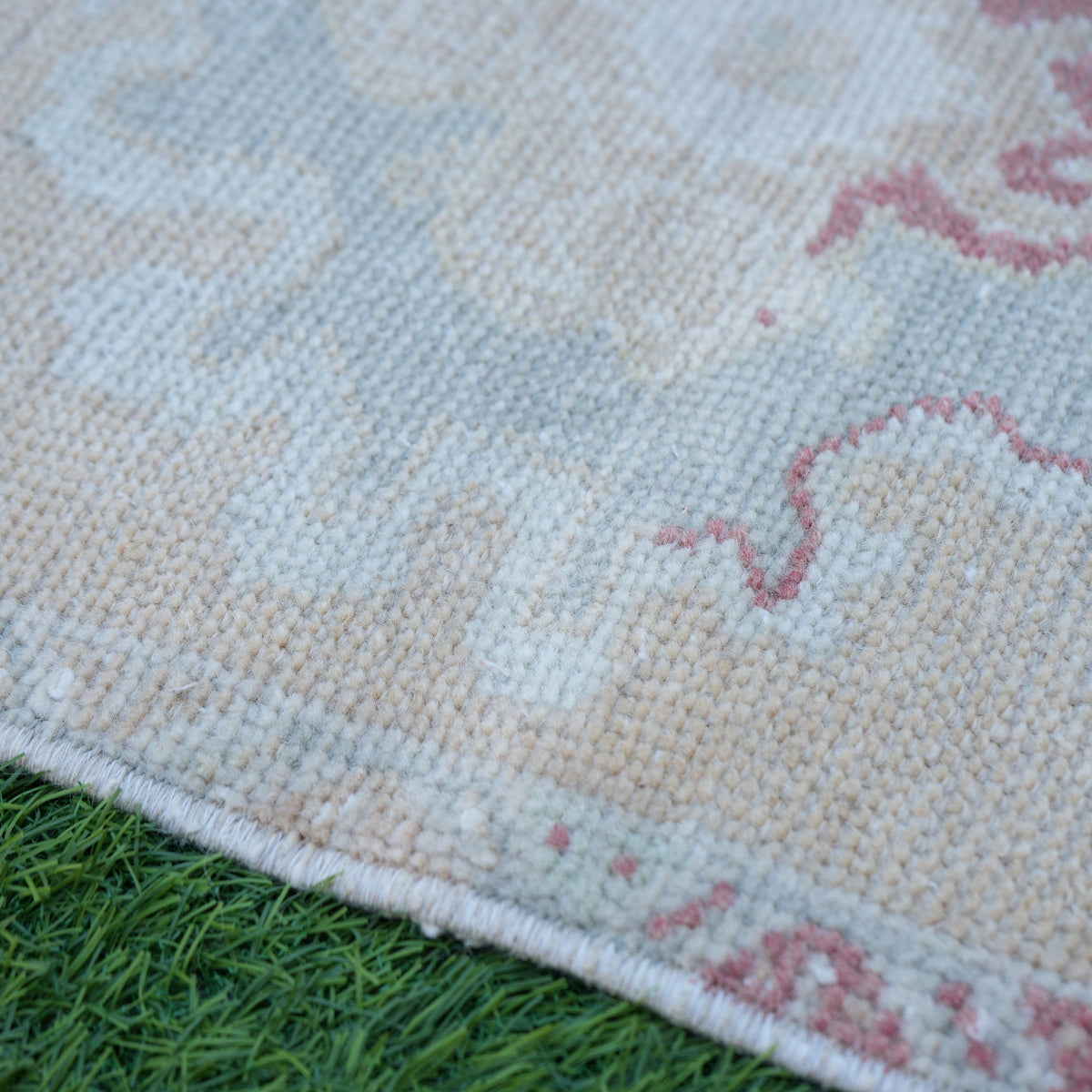 Beige 1' x 3' vintage turkish rug in wool and cotton, shown on the floor.