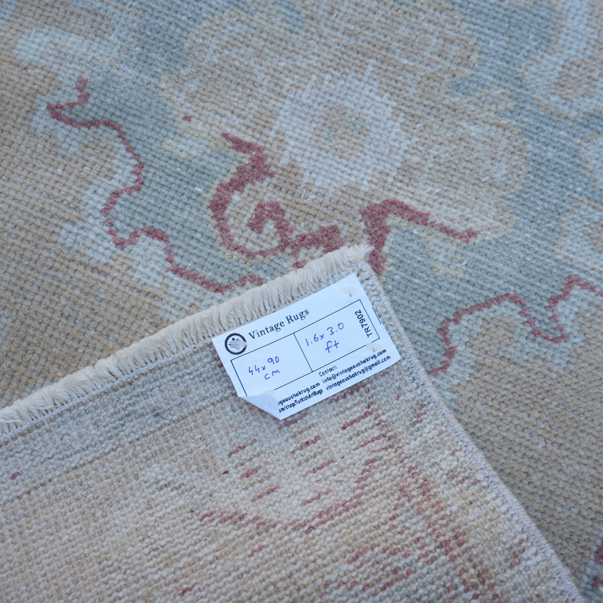 Beige 1' x 3' vintage turkish rug from the 1970s with traditional design.