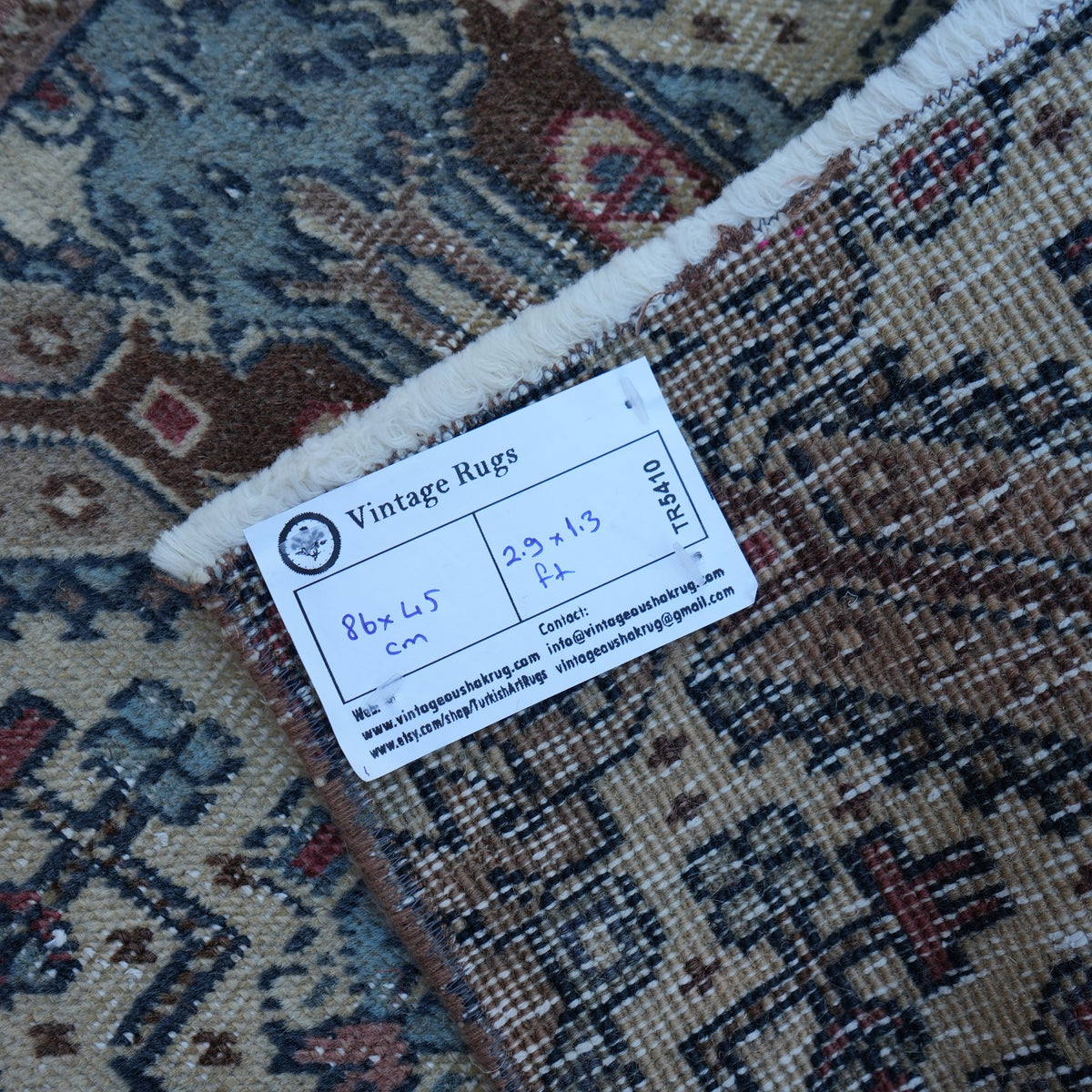 Brown 1' x 3' vintage turkish rug from the 1970s with traditional design.