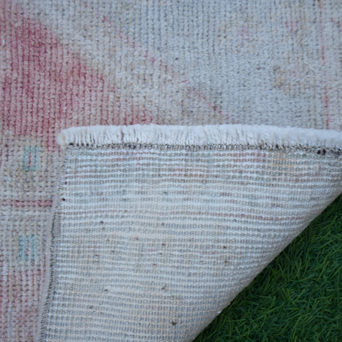 1970s pale red vintage turkish rug with neutral design, hand-knotted weave and low pile.