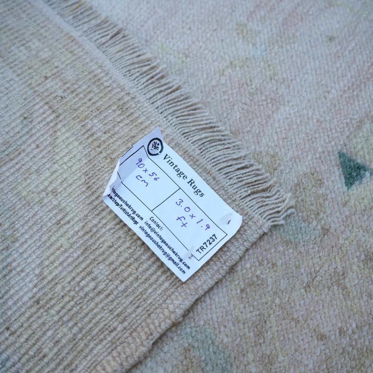 Beige 2' x 3' vintage turkish rug from the 1970s with neutral design.