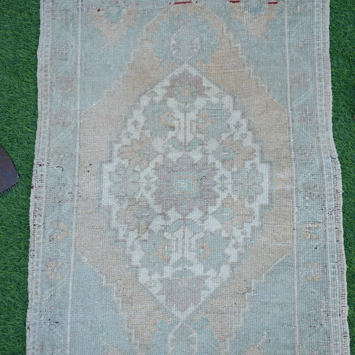 Close-up of the brown vintage turkish rug showing neutral details, hand-knotted weave, wool and cotton and low pile.