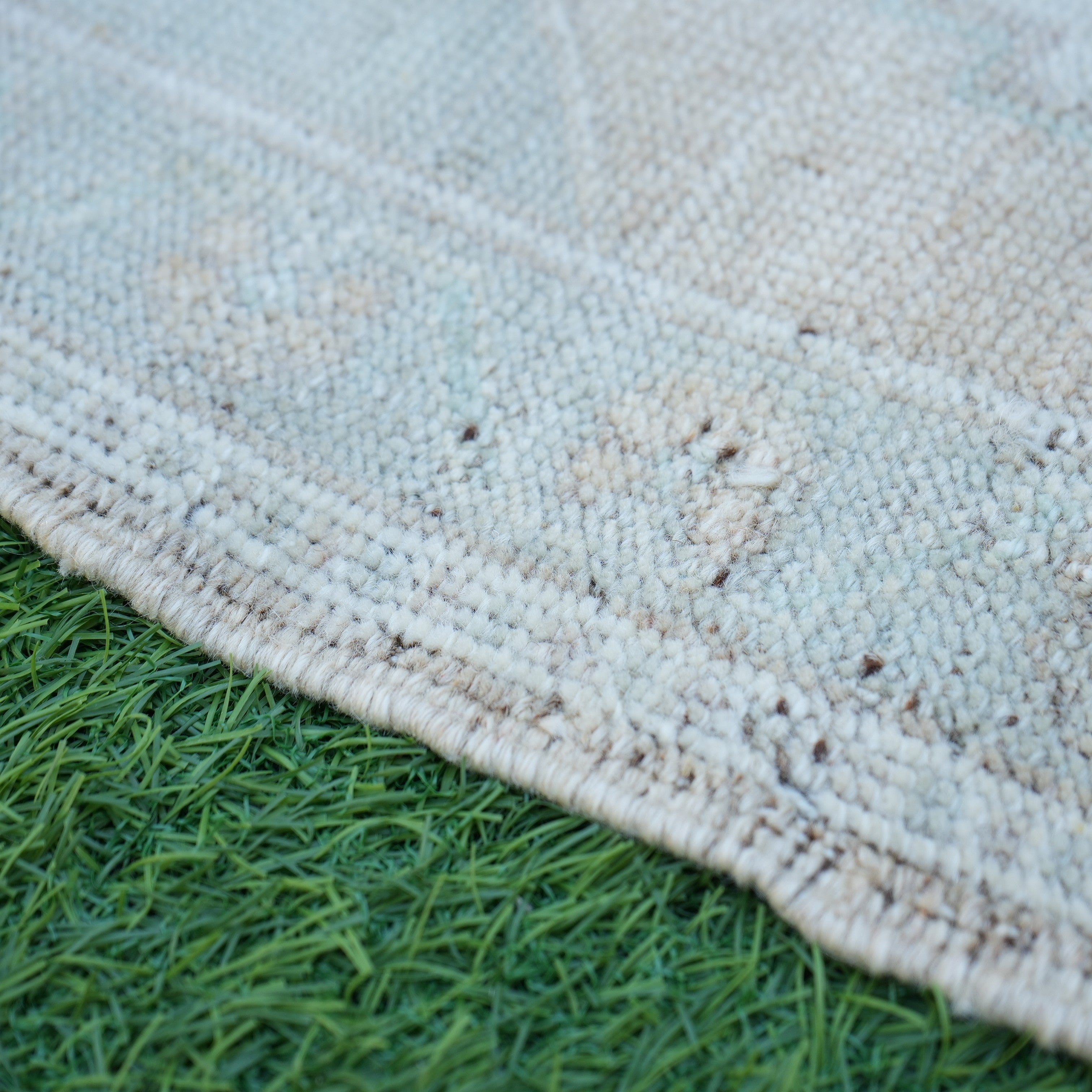 Brown 2' x 3' vintage turkish rug in wool and cotton, shown on the floor.