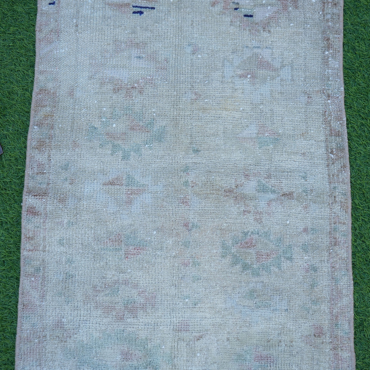 Close-up of the brown vintage turkish rug showing neutral details, hand-knotted weave, wool and cotton and low pile.