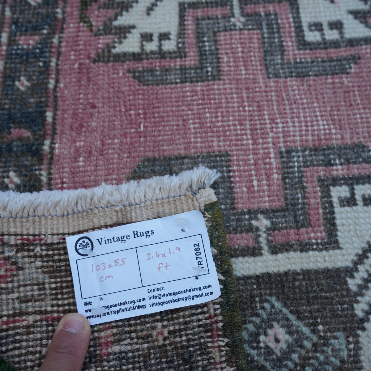 Pink 2' x 3' vintage turkish rug from the 1970s with traditional design.