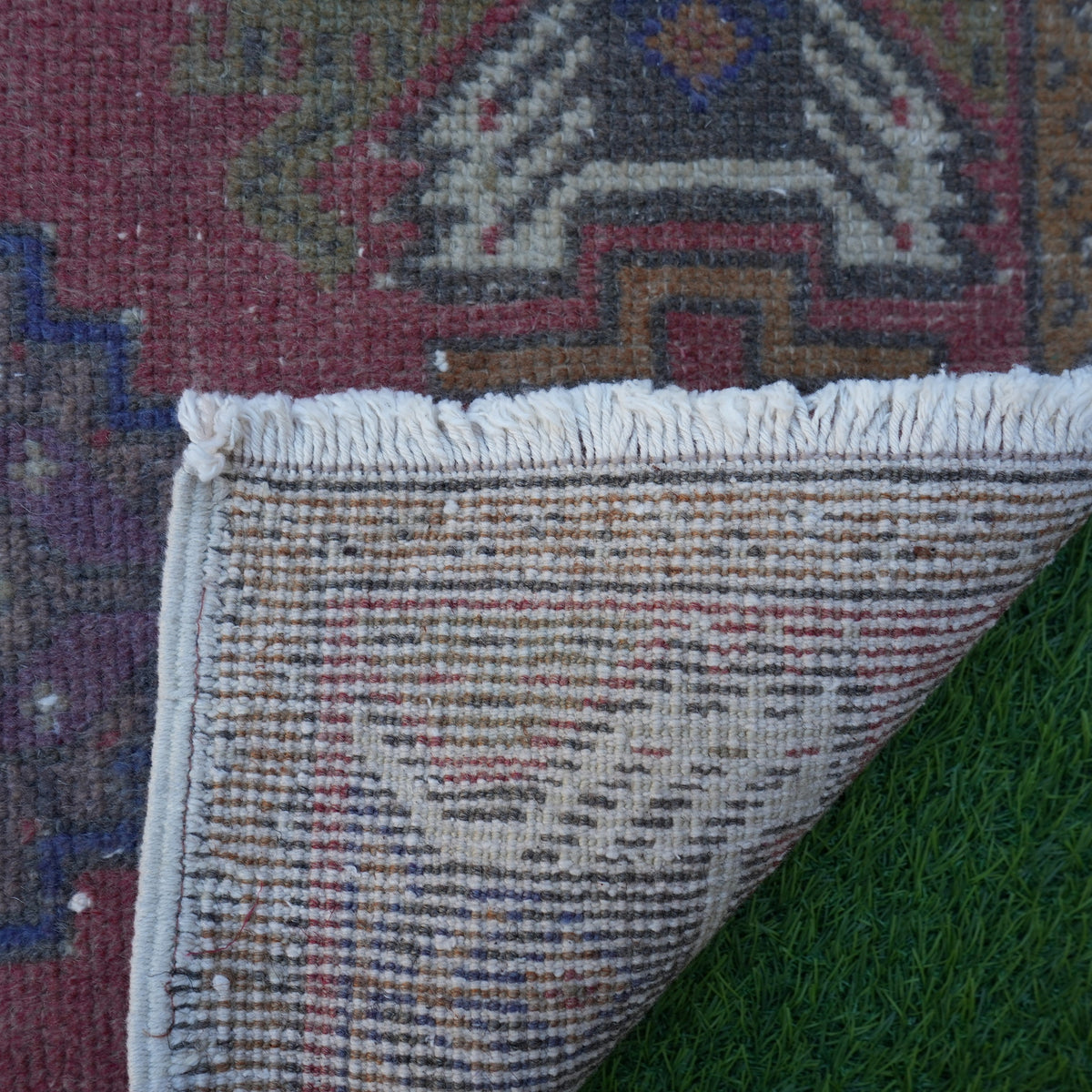 1970s red vintage turkish rug with geometric design, hand-knotted weave and low pile.