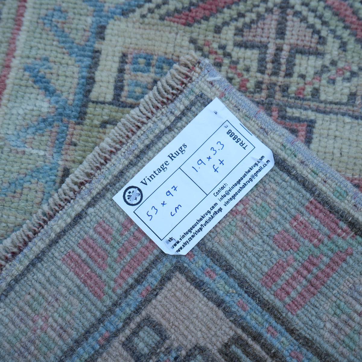Red 2' x 3' vintage turkish rug from the 1970s with traditional design.