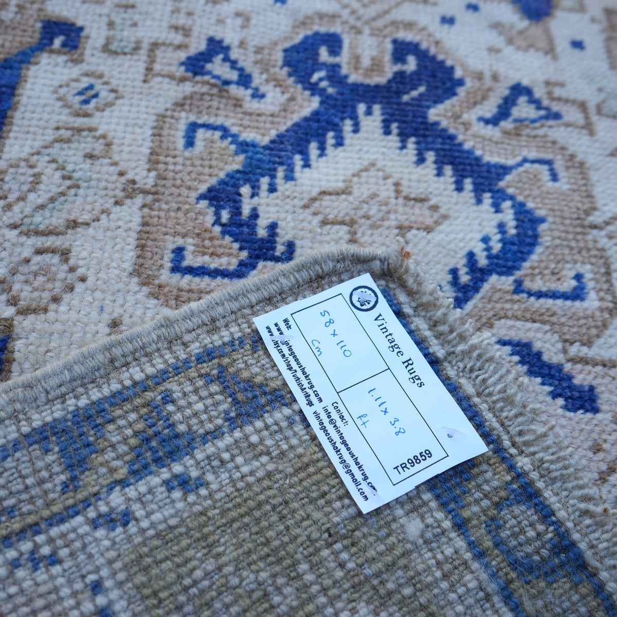 Blue 2' x 4' vintage turkish rug from the 1970s with traditional design.