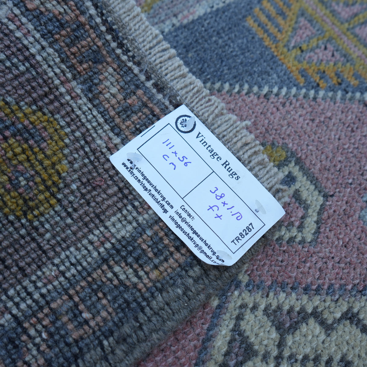 Pink 2' x 4' vintage turkish rug from the 1970s with traditional design.