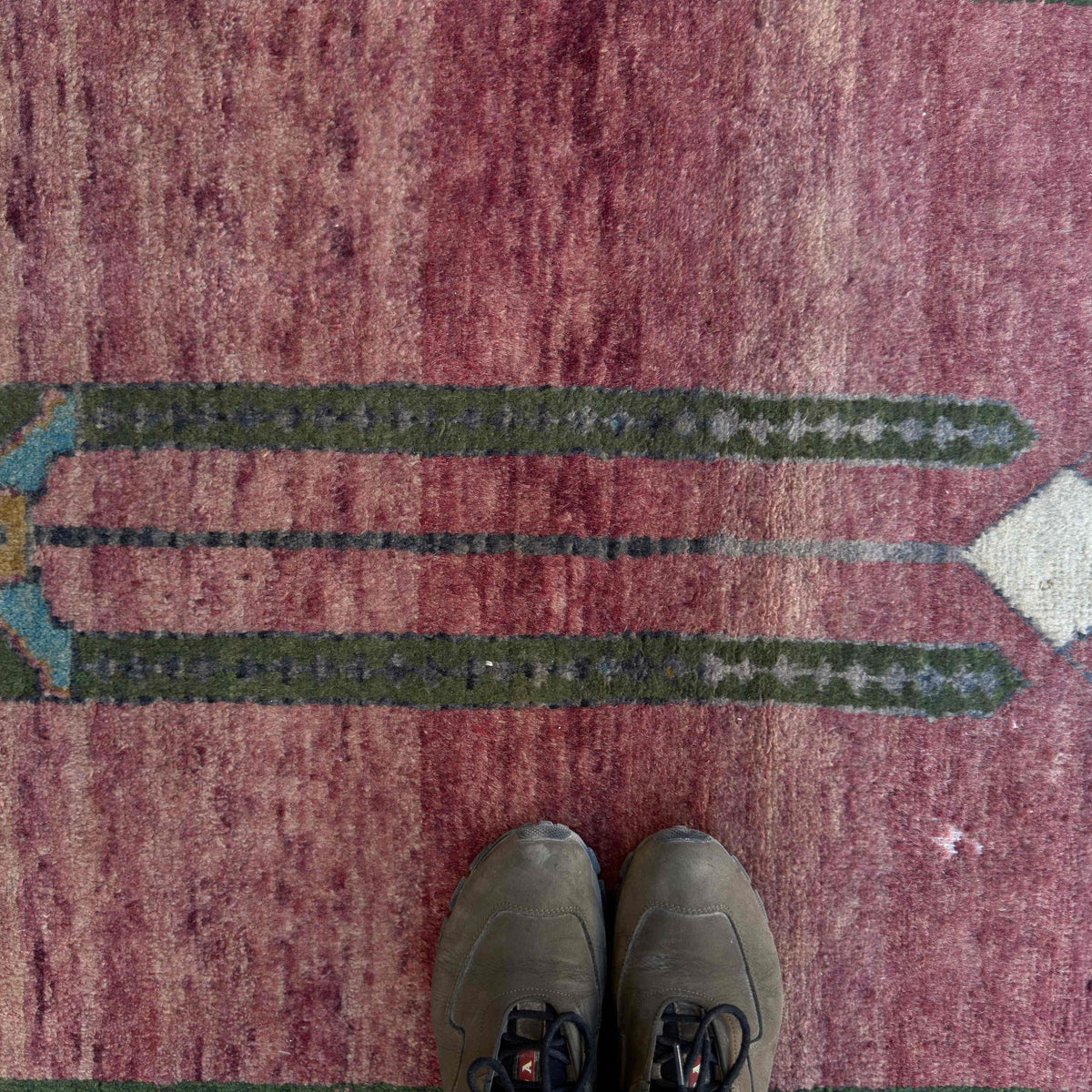 1970s red vintage turkish rug with traditional design, hand-knotted weave and low pile.