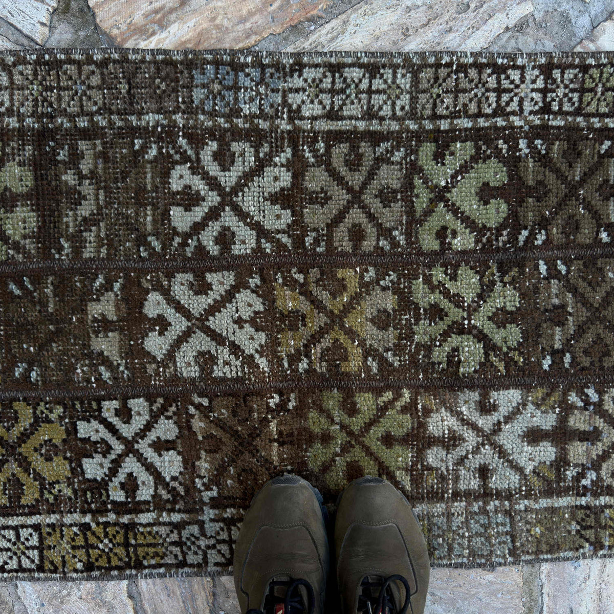 1970s brown vintage turkish rug with patchwork design, hand-knotted weave and low pile.