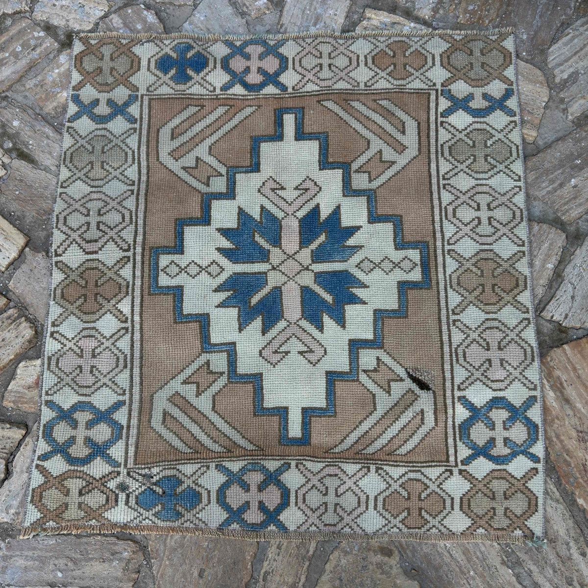 Blue 3' x 3' vintage turkish rug in wool and cotton, shown on the floor.