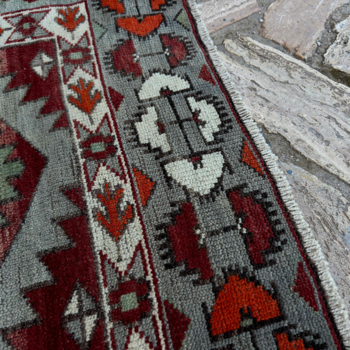 Close-up of the blue vintage turkish rug showing traditional details, hand-knotted weave, wool and cotton and low pile.