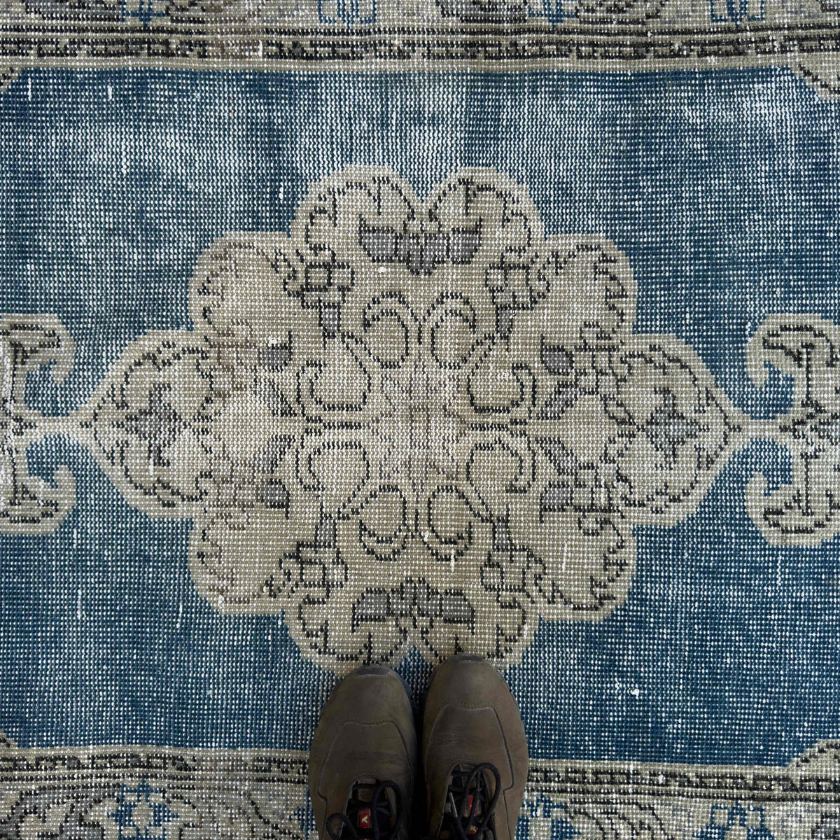 1970s blue vintage turkish rug with geometric design, hand-knotted weave and low pile.