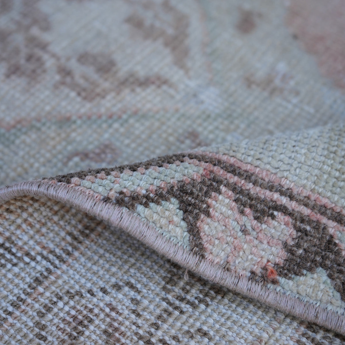 Additional view of the pink vintage turkish rug, hand-knotted in wool.