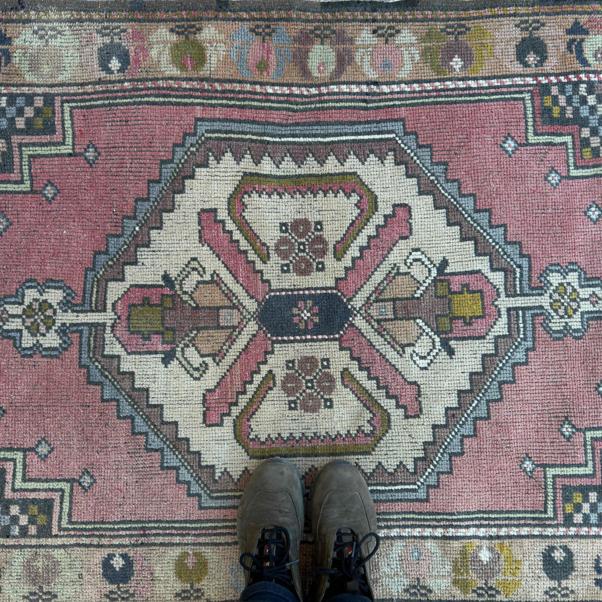 1970s pink vintage turkish rug with traditional design, hand-knotted weave and low pile.