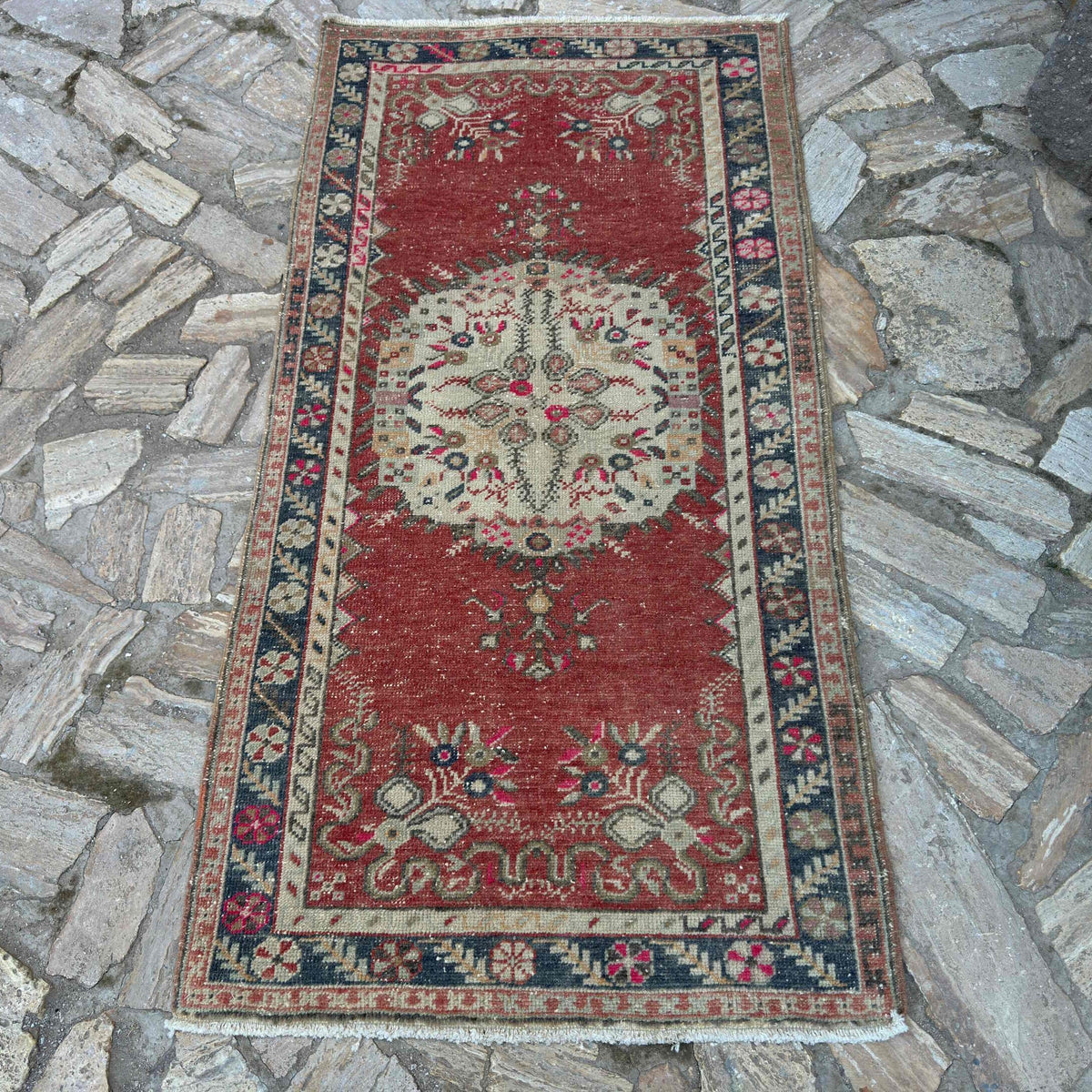 Red 3' x 6' vintage turkish rug in wool and cotton, shown on the floor.