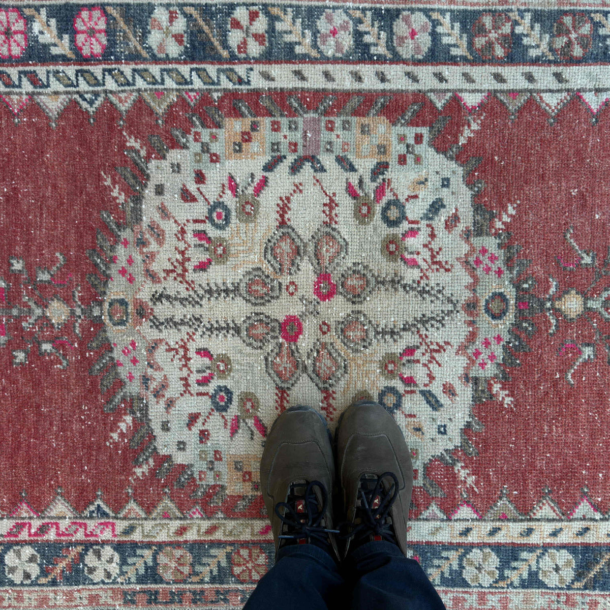 1970s red vintage turkish rug with geometric design, hand-knotted weave and low pile.