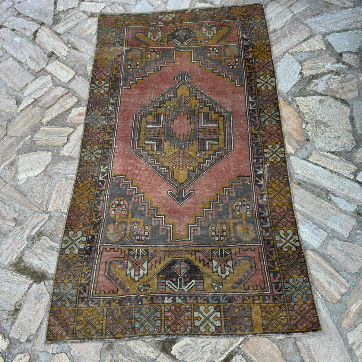 Red 3' x 6' vintage turkish rug in wool and cotton, shown on the floor.