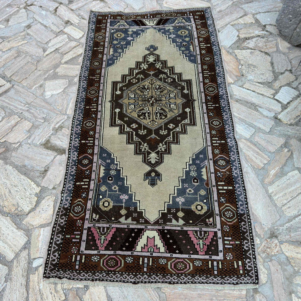 Blue 3' x 7' vintage turkish rug in wool and cotton, shown on the floor.