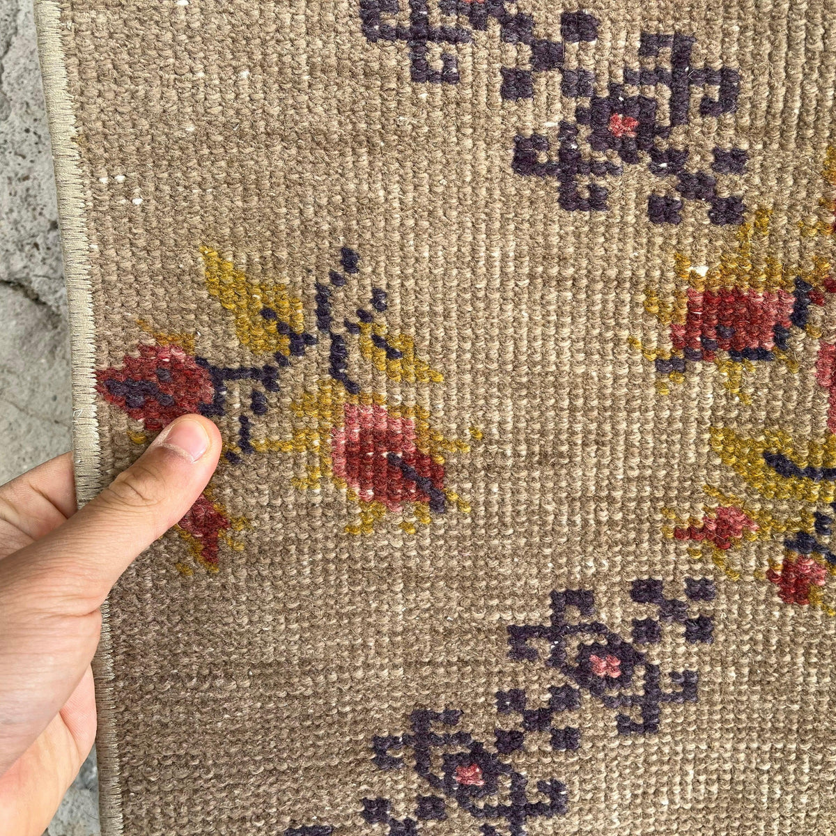 Close-up of the brown vintage turkish rug showing traditional details, hand-knotted weave, wool and cotton and low pile.