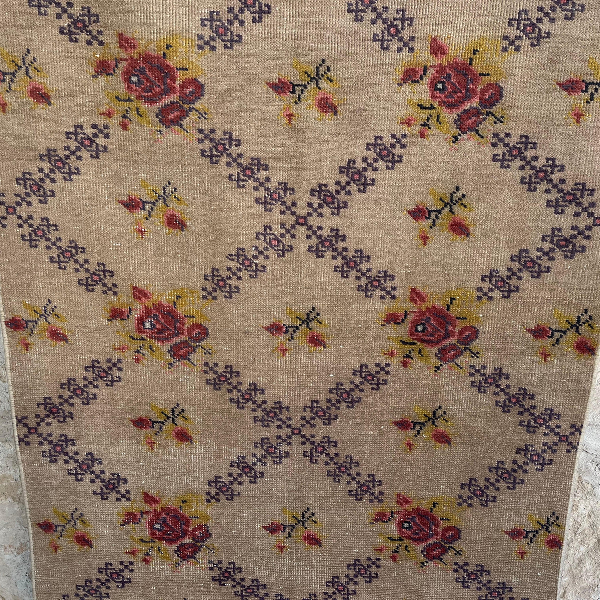 Brown 3' x 7' vintage turkish rug in wool and cotton, shown on the floor.
